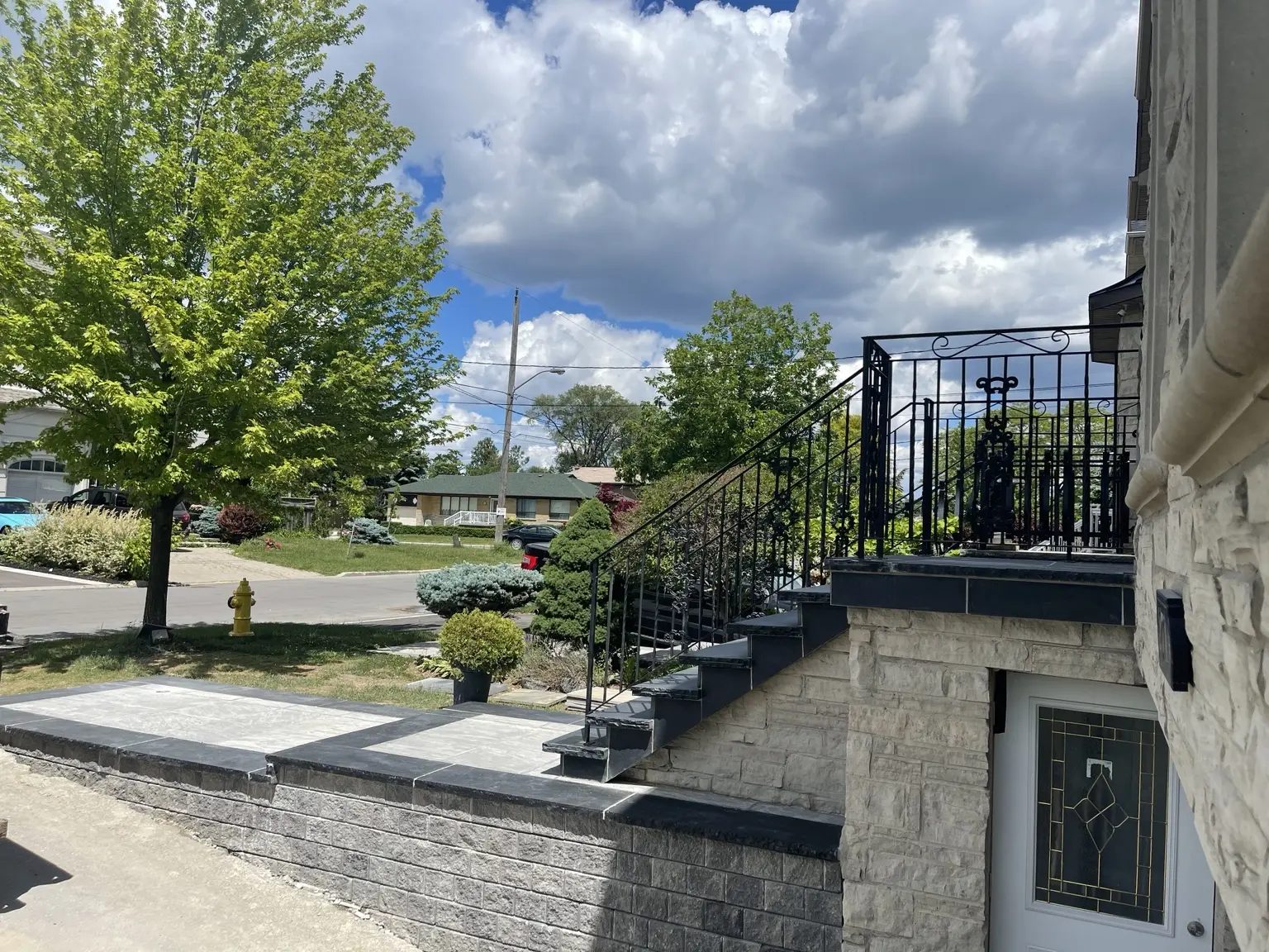 Side view of premium dark stone steps and custom decorative metal railings