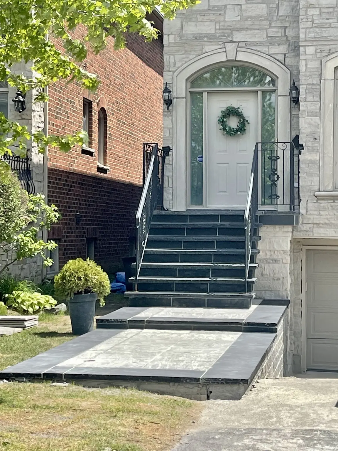 Dark stone staircase, landing and walkway during the entrance renovation