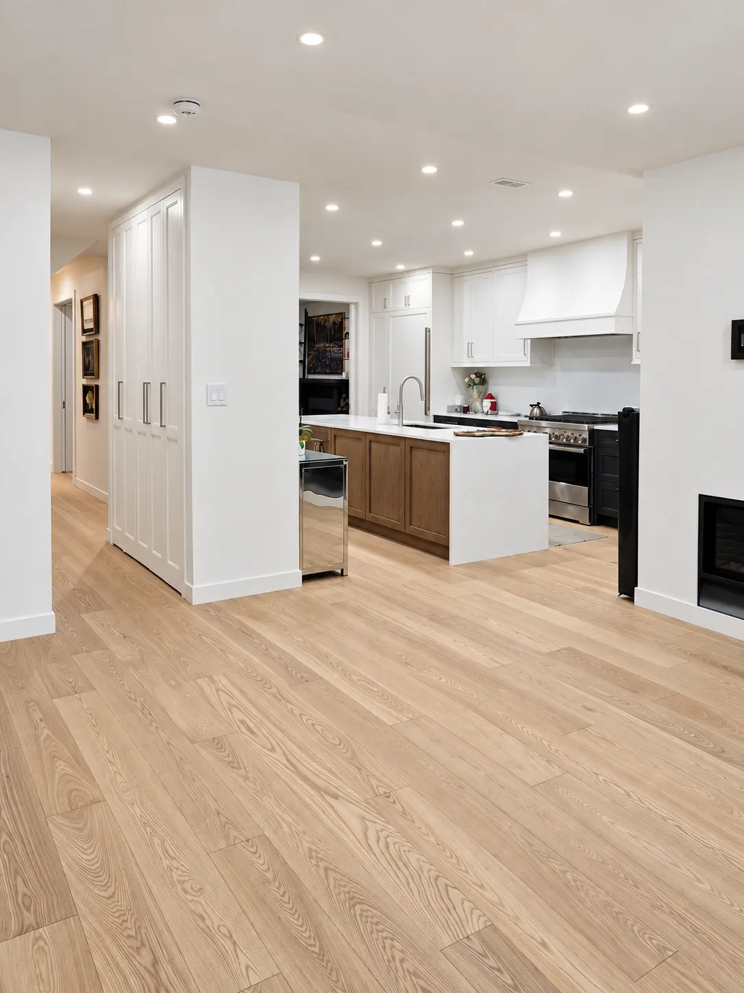Open-plan kitchen and main floor with oak flooring and custom cabinetry