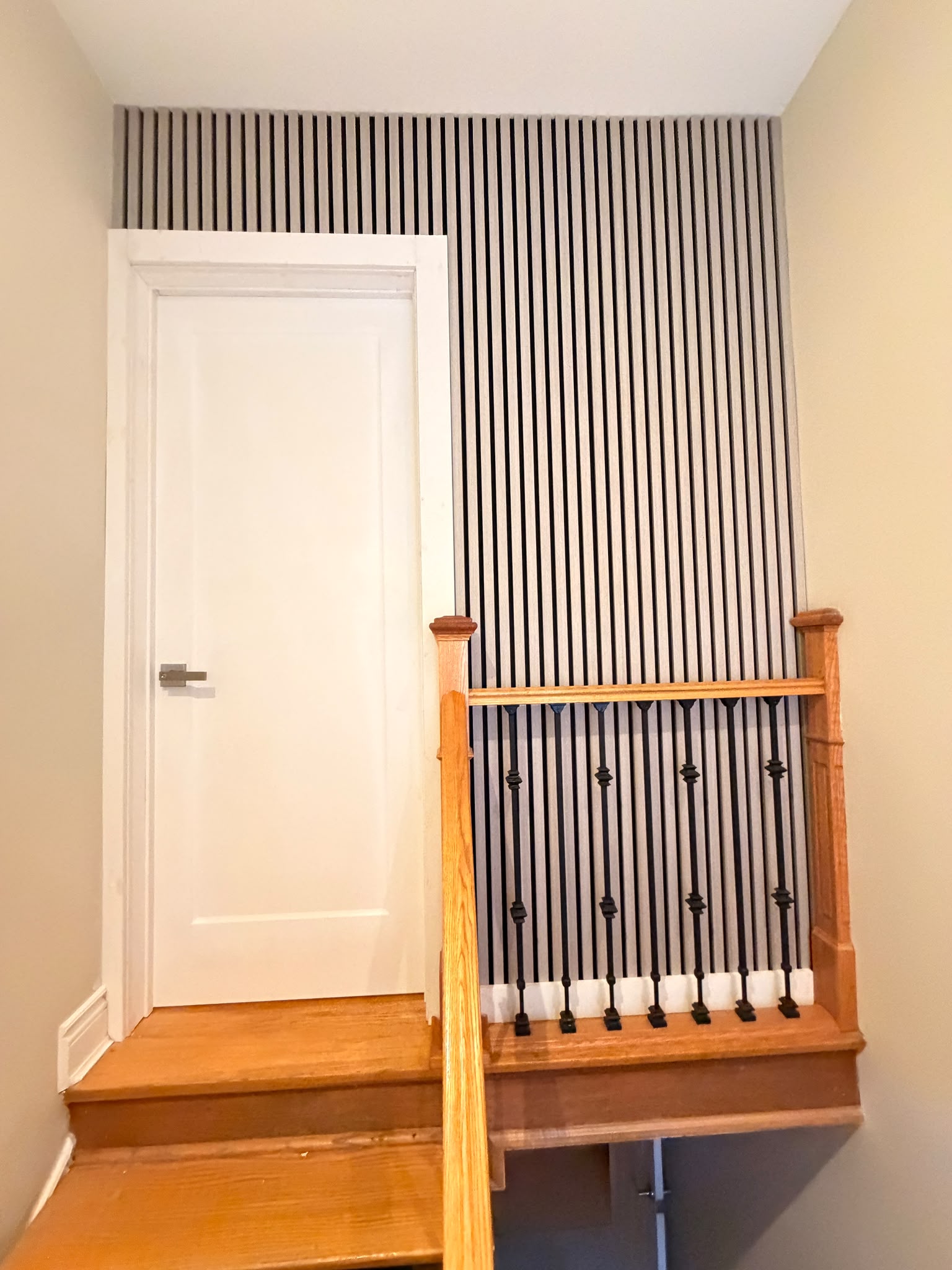 Vertical slat feature wall integrated with the existing staircase and new interior door