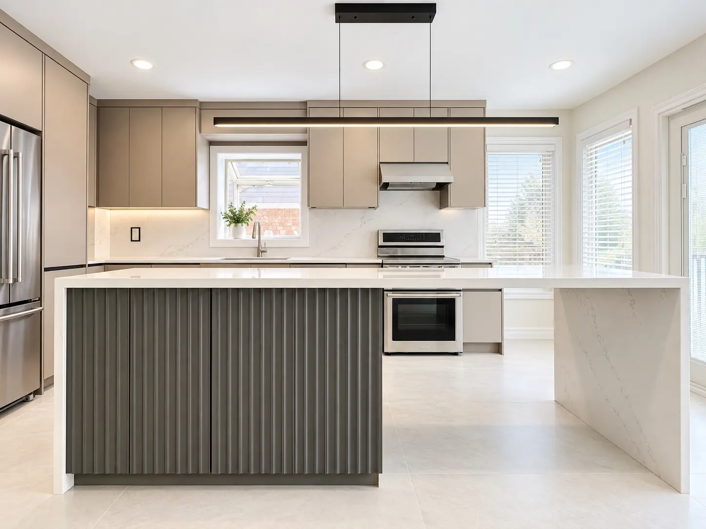 Wide front view of the completed contemporary kitchen and oversized waterfall island