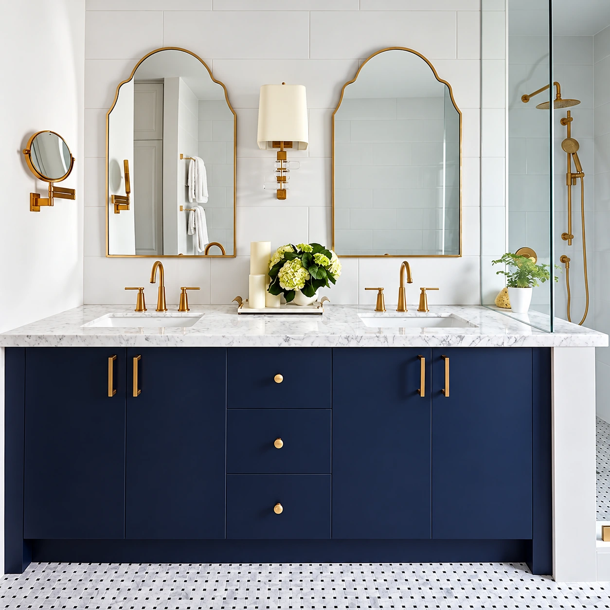 Navy double vanity with marble countertop, two brass-framed mirrors and brass faucets